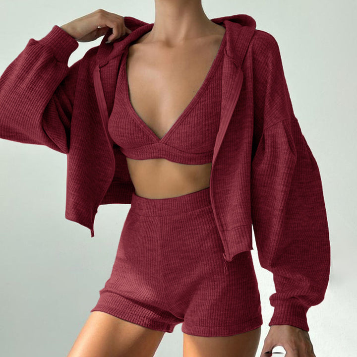 Maroon ribbed knit outfit with a jacket on a plain background