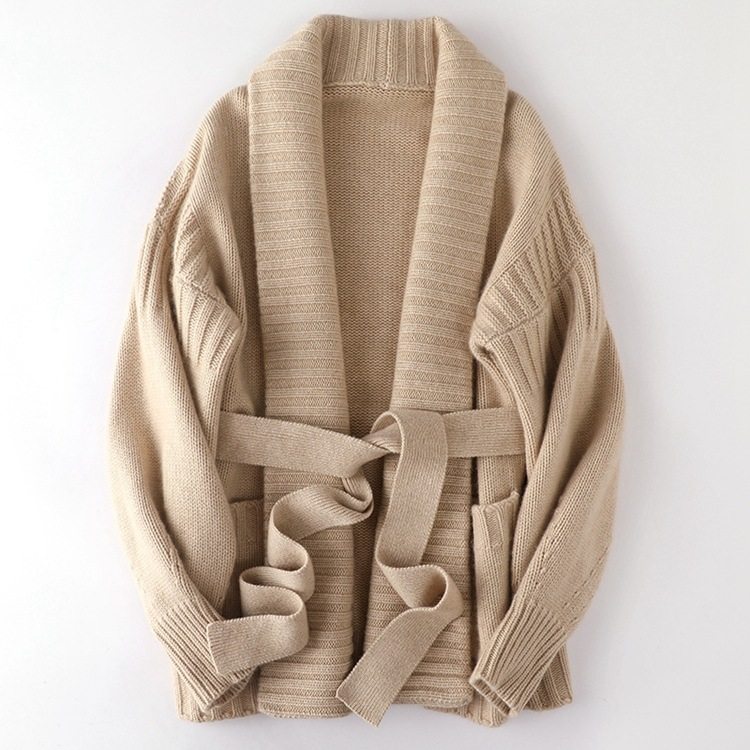 Beige cardigan with a belt on a white background