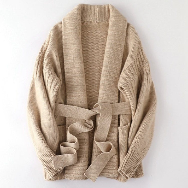 Beige cardigan with a belt on a white background