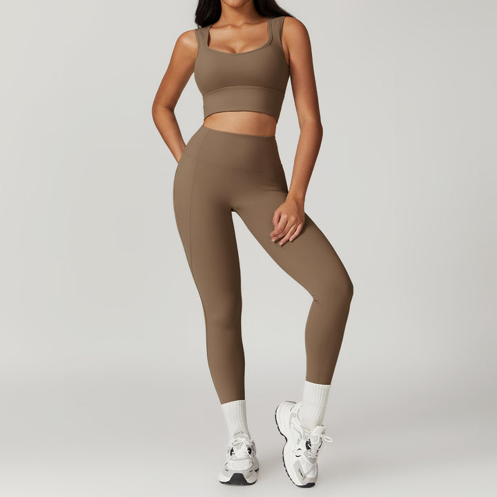 Person wearing a brown sports bra and leggings set on a gray background