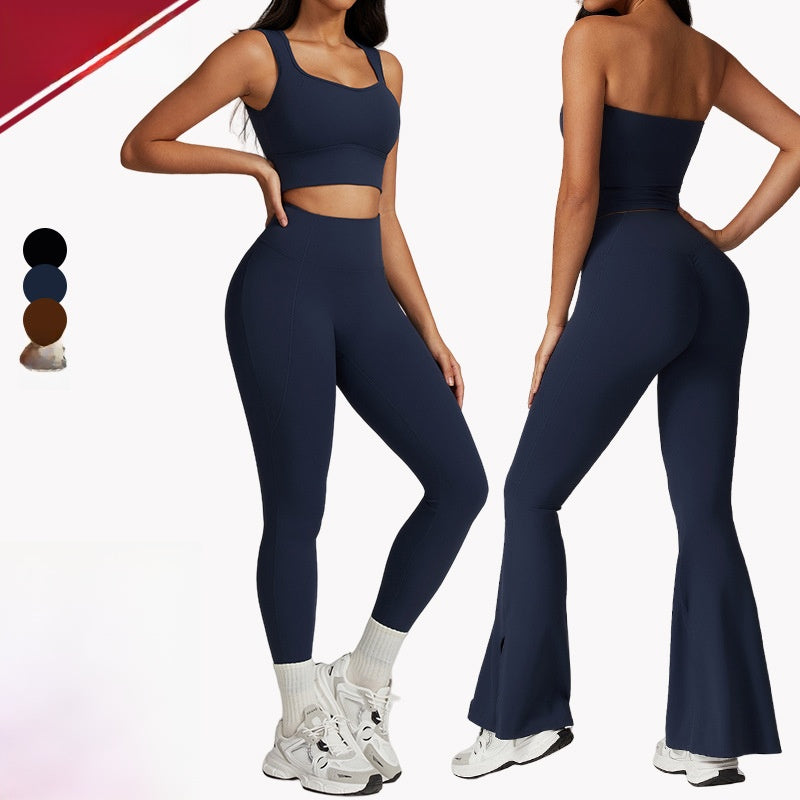 Woman wearing navy blue athletic outfit with flared leggings on a white background
