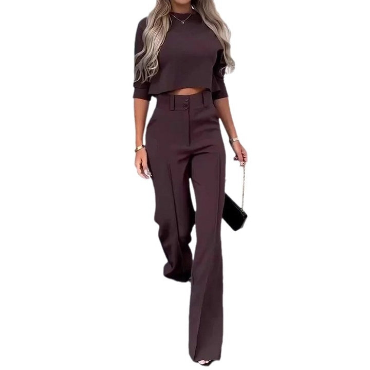 Woman wearing a brown outfit with a high-waisted pants and crop top on a white background
