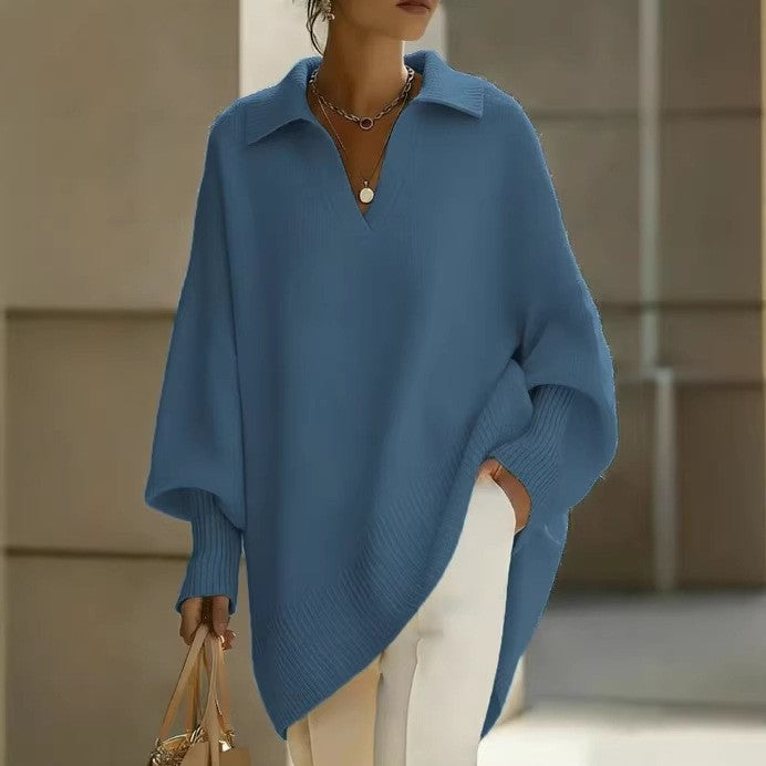 Person wearing a blue sweater with a neutral background