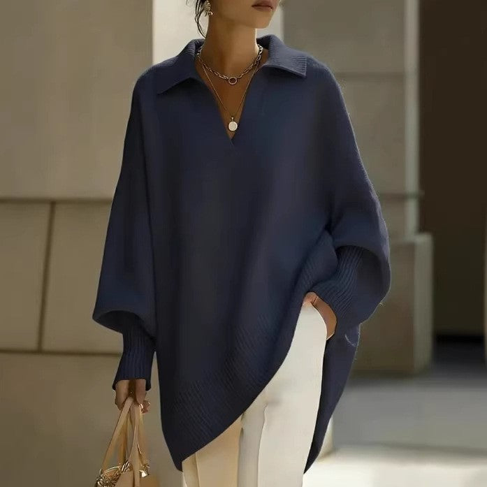 Person wearing a navy blue poncho with a blurred background