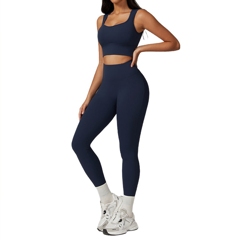 Person wearing a navy blue athletic outfit on a white background