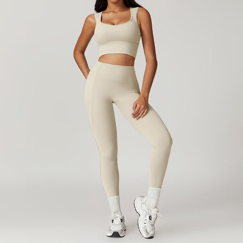 Person wearing a beige athletic outfit on a plain background