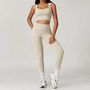 Person wearing a beige athletic outfit on a plain background