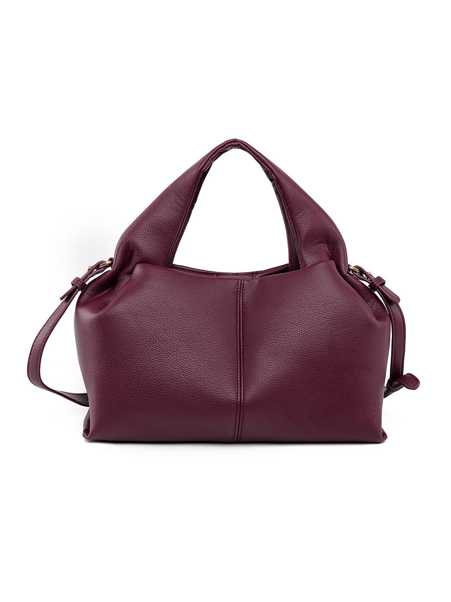 Burgundy leather handbag on a white background