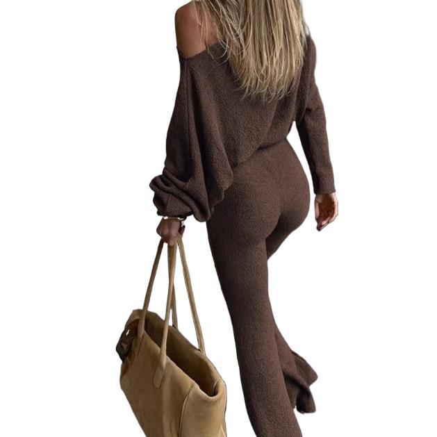Woman wearing a brown outfit holding a beige bag on a white background