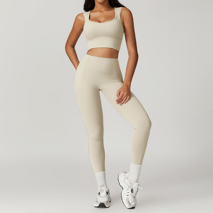 Person wearing a beige athletic outfit on a plain background