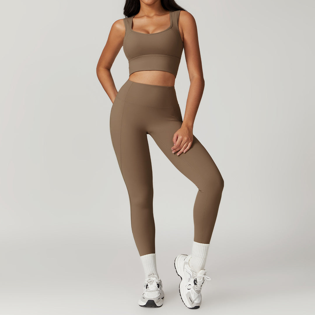 Person wearing a brown sports bra and leggings set on a gray background