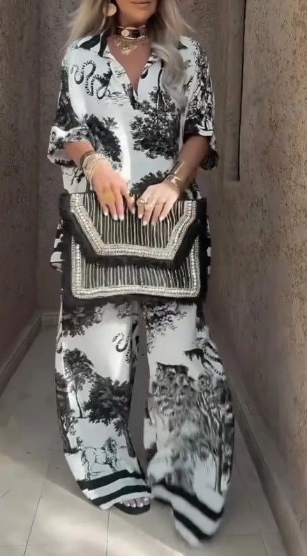 Person wearing a black and white patterned outfit with a matching handbag.