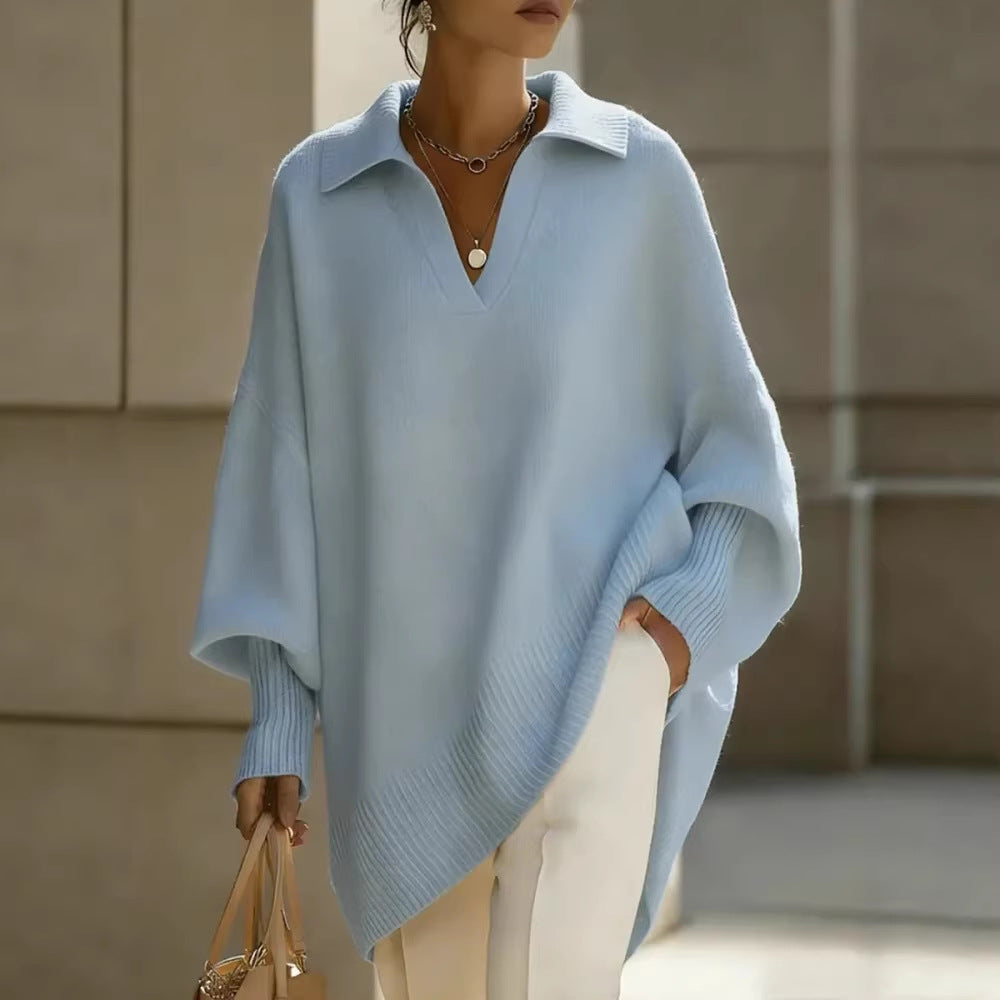 Person wearing a light blue poncho against a neutral background