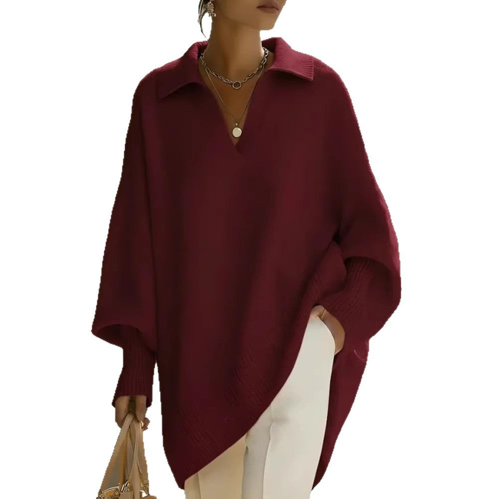 Person wearing a burgundy poncho on a white background
