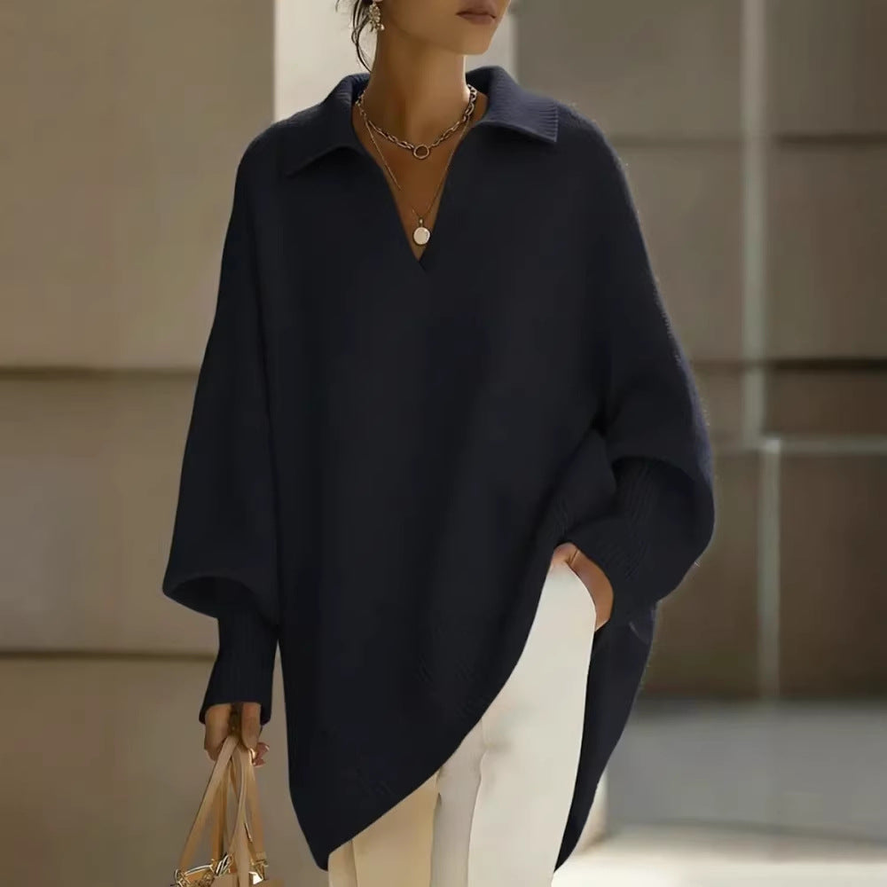 Person wearing a navy blue poncho with a blurred background