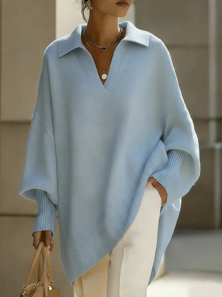 Person wearing a light blue poncho with a blurred background