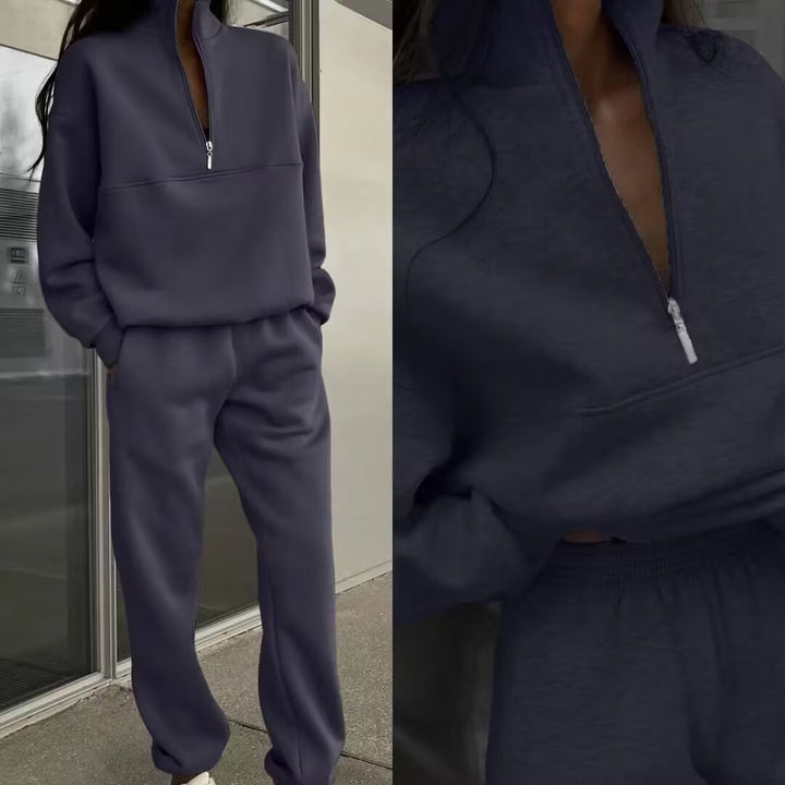 Navy blue tracksuit worn by a person, with a close-up of the front pocket.