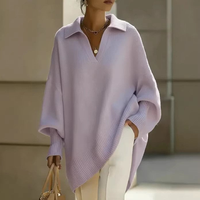 Person wearing a light purple poncho with a neutral background