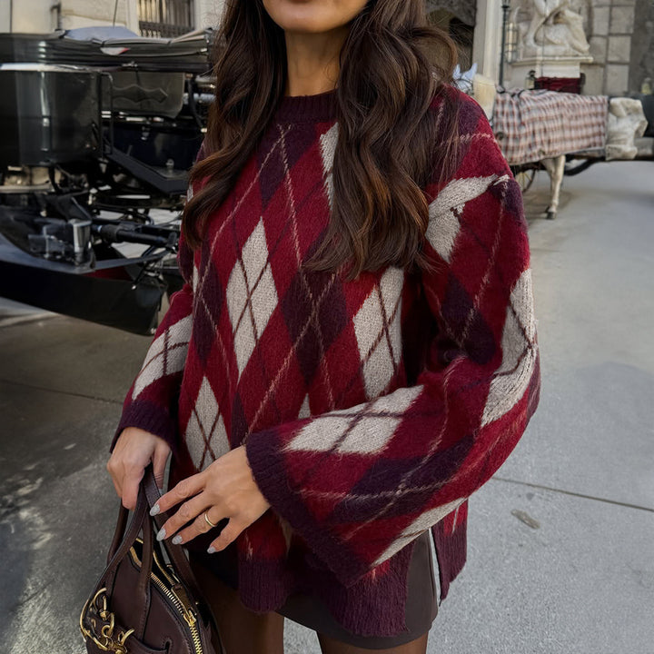 Person wearing a red and white patterned poncho in an indoor setting.