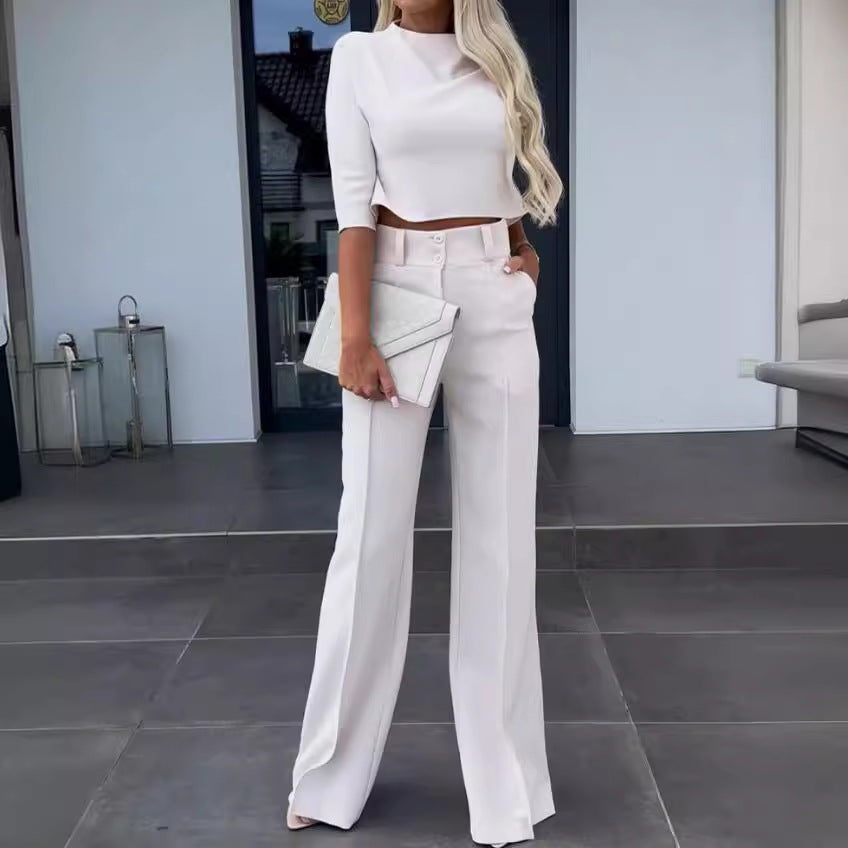 Woman in a white outfit standing in an outdoor setting