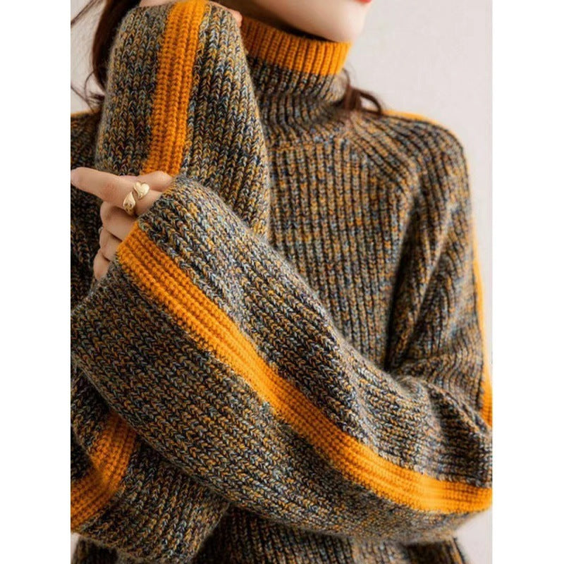 Close-up of a person wearing a gray and orange sweater with a blurred background