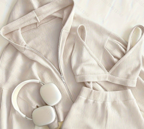 Beige dress with white headphones on a matching fabric background